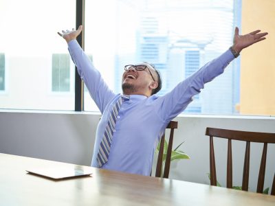 Happy business owner celebrating increased sales after using Vidifye for video ads.
