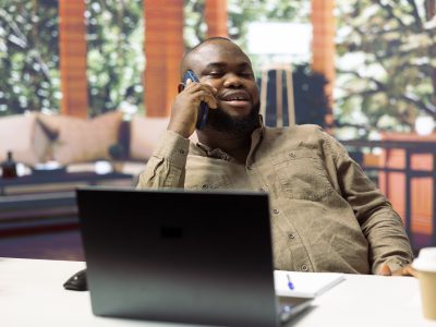 A happy business owner on the phone, excited about using Vidifye to boost his sales with video ads.