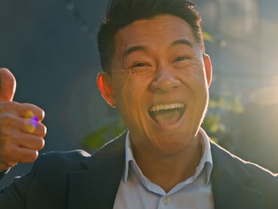 Happy businessman smiling confidently after achieving success using Vidifye for video classifieds.